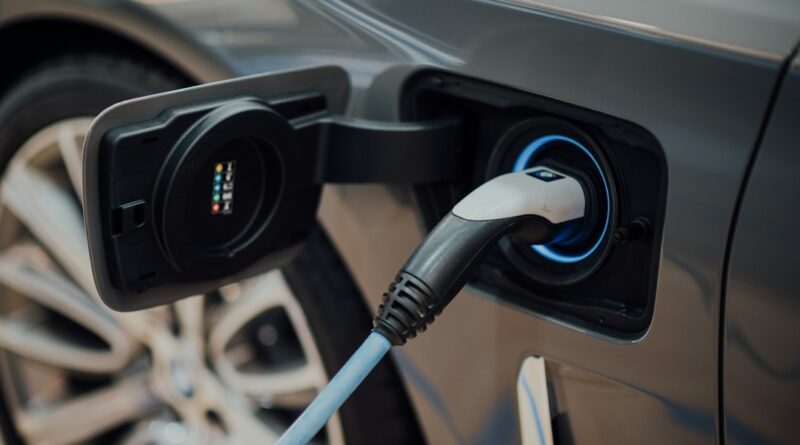 electric vehicle charging cable plugged into car